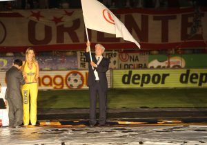 Mario Vargas Llosa flameando la bandera de Universitario, club del que es hincha.